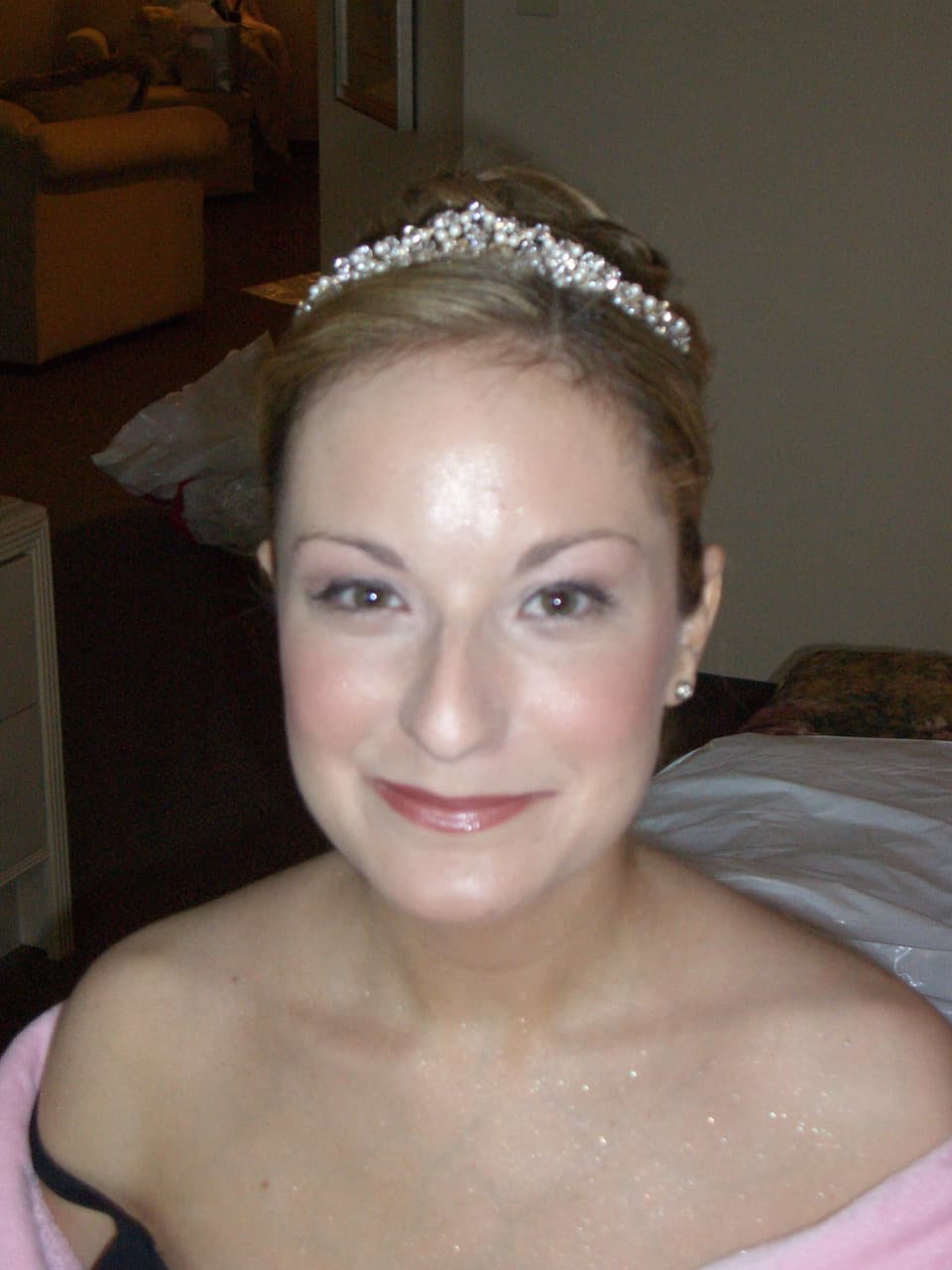 Smiling bride in a pearl tiara, getting ready before the wedding